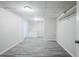 Finished basement with gray plank flooring, white walls, and ceiling lighting at 49 Sweetwater Ct, Powder Springs, GA 30127