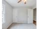 Bedroom featuring a ceiling fan, window, and doorway access to another room at 49 Sweetwater Ct, Powder Springs, GA 30127