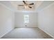 Tranquil bedroom with plush carpeting, a ceiling fan, and soft natural light creating a serene, relaxing atmosphere at 49 Sweetwater Ct, Powder Springs, GA 30127