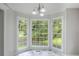 Sunlit breakfast nook featuring bright windows, marble floors, and contemporary chandelier lighting, perfect for morning enjoyment at 49 Sweetwater Ct, Powder Springs, GA 30127