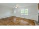 Spacious living room with hardwood floors, a stone fireplace, and decorative wall trim offering a warm, inviting ambiance at 49 Sweetwater Ct, Powder Springs, GA 30127