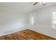 Inviting room with hardwood floors, decorative wall trim, and a bright window creating a cozy, stylish space at 49 Sweetwater Ct, Powder Springs, GA 30127