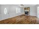 Spacious living room with hardwood floors, a stone fireplace, and decorative wall trim offering a warm, inviting ambiance at 49 Sweetwater Ct, Powder Springs, GA 30127