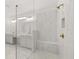 Luxurious shower in primary bathroom with bench seating, glass surround, and marble-style tile at 778 Brooke View Drive, Canton, GA 30115