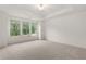 Bright bedroom with plush carpeting and large windows overlooking a wooded area at 778 Brooke View Drive, Canton, GA 30115