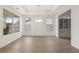 Bright dining room with hardwood flooring, large windows, a stylish chandelier, and wainscoting details at 778 Brooke View Drive, Canton, GA 30115