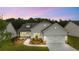 Beautiful single-story home with a two-car garage, manicured lawn, and stone accents at dusk at 778 Brooke View Drive, Canton, GA 30115