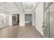 Bright, open-concept foyer with hardwood floors, built-in shelves, and modern light fixtures at 778 Brooke View Drive, Canton, GA 30115