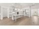 Open kitchen with stainless steel appliances, a large center island, and light hardwood floors at 778 Brooke View Drive, Canton, GA 30115