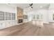 Spacious living room with a stone fireplace, built-in bookshelves, hardwood floors, and many windows at 778 Brooke View Drive, Canton, GA 30115
