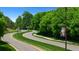 Scenic community entrance with winding roads, lush landscaping, and decorative street lighting at 778 Brooke View Drive, Canton, GA 30115