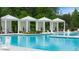 Relaxing pool scene with pristine cabanas and clear blue water reflecting the idyllic surroundings at 778 Brooke View Drive, Canton, GA 30115