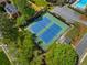 Aerial view of tennis court in neighborhood surrounded by trees at 2830 Scottish Mill Way, Marietta, GA 30068