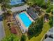 Aerial view of the community pool and deck area, surrounded by trees and a building at 2830 Scottish Mill Way, Marietta, GA 30068