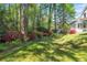 Serene backyard with mature trees and vibrant flowering bushes providing shade and color at 2830 Scottish Mill Way, Marietta, GA 30068