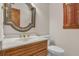 Elegant powder room featuring granite counters, decorative mirror, and wood shutters at 2830 Scottish Mill Way, Marietta, GA 30068