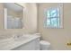 Bathroom with a white vanity, marble countertop, and a window at 2830 Scottish Mill Way, Marietta, GA 30068