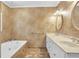 Bathroom featuring tub, dual sink vanity, and elegant marble-like walls at 2830 Scottish Mill Way, Marietta, GA 30068