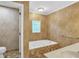 Bathroom featuring a bathtub, stylish brown tiled walls, and a vanity with sink at 2830 Scottish Mill Way, Marietta, GA 30068
