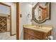 Cozy bathroom with wood cabinets, granite countertop, and decorative mirror and fixtures at 2830 Scottish Mill Way, Marietta, GA 30068