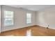 Bedroom with two windows letting in natural light and gleaming hardwood floors at 2830 Scottish Mill Way, Marietta, GA 30068