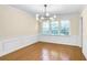 Formal dining room offers hardwood floors, modern chandelier, and wainscoting at 2830 Scottish Mill Way, Marietta, GA 30068
