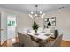 Elegant dining room with a marble-top table, stylish chandelier, and modern art at 2830 Scottish Mill Way, Marietta, GA 30068