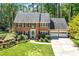 Charming brick home with a well-manicured lawn, mature trees, and an attached two-car garage at 2830 Scottish Mill Way, Marietta, GA 30068