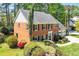 Charming brick home with a well-manicured lawn, mature trees, and an attached two-car garage at 2830 Scottish Mill Way, Marietta, GA 30068