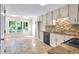 Bright eat-in kitchen features tile floors, granite counters, tile backsplash, and lots of natural light at 2830 Scottish Mill Way, Marietta, GA 30068