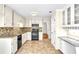 Bright kitchen with tile floors, granite countertops, stainless appliances, and a convenient desk area at 2830 Scottish Mill Way, Marietta, GA 30068