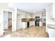 Spacious kitchen with tile floors, black appliances, tile backsplash and adjacent laundry room at 2830 Scottish Mill Way, Marietta, GA 30068