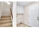 Convenient laundry room with storage cabinets located near a carpeted staircase at 2830 Scottish Mill Way, Marietta, GA 30068