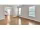Light-filled living room boasting hardwood floors, crown molding, and two windows at 2830 Scottish Mill Way, Marietta, GA 30068