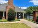 Community pool entrance with brick pillars, black metal fence, and manicured landscaping at 2830 Scottish Mill Way, Marietta, GA 30068