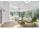 Bright sunroom featuring skylights, tile flooring, ceiling fan and casual seating with tranquil backyard views at 2830 Scottish Mill Way, Marietta, GA 30068