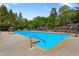 Large community swimming pool with lounge chairs, umbrellas, and mature trees at 2830 Scottish Mill Way, Marietta, GA 30068