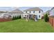 Spacious backyard with a covered patio, playset, and manicured lawn at 4365 Sunflower Cir, Cumming, GA 30040