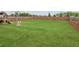 Large, well-maintained backyard with a swing set and a wooden fence at 4365 Sunflower Cir, Cumming, GA 30040