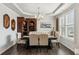 Elegant dining room with modern chandelier, and decor with luxury chairs, table and hutch at 4365 Sunflower Cir, Cumming, GA 30040