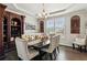 Dining room showcasing a wooden table, cushioned chairs, and stylish decor, creating a warm ambiance at 4365 Sunflower Cir, Cumming, GA 30040