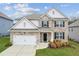 Charming two-story home with a well-manicured lawn, brick facade, and an attached two-car garage at 4365 Sunflower Cir, Cumming, GA 30040