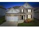 Traditional two-story home with brick facade, attached garage, and well-manicured lawn offering great curb appeal at 4365 Sunflower Cir, Cumming, GA 30040