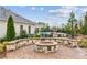 Outdoor fire pit area with stone seating is the perfect space for relaxing and socializing with neighbors at 4365 Sunflower Cir, Cumming, GA 30040