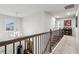 Well-lit upstairs hallway featuring dark wood railings and an elegant chandelier at 4365 Sunflower Cir, Cumming, GA 30040