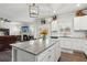 Beautiful kitchen with white cabinets, granite counters, stainless appliances, and open to living room at 4365 Sunflower Cir, Cumming, GA 30040