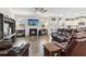 Cozy living room with a fireplace, TV, hardwood floors, and comfortable seating at 4365 Sunflower Cir, Cumming, GA 30040