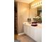 Bathroom featuring white cabinets, white countertops, and a mirror at 978 Francis Ln, Fairburn, GA 30213