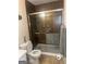 Bathroom featuring a toilet, a walk-in shower, and tiled floors at 978 Francis Ln, Fairburn, GA 30213