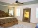 Spacious main bedroom featuring a ceiling fan, carpet, and bedside tables with lamps at 978 Francis Ln, Fairburn, GA 30213